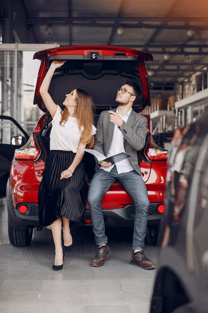 A man and women sitting in the back of car 